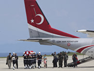 Police officers carry the Turkish flag-draped coffin of police officer Ahmet Camur