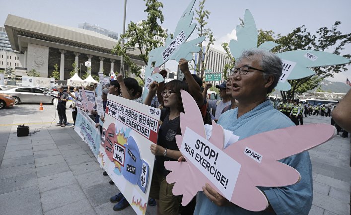 Protesters shout slogans during a rally demanding to stop the US-South Korean joint military exercises