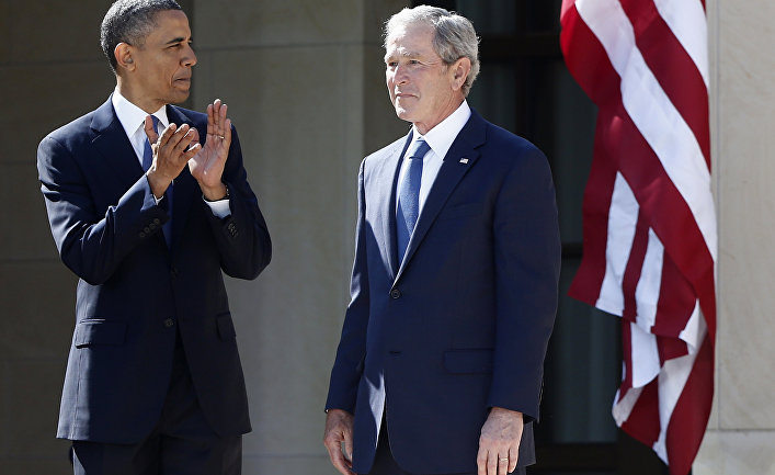 President Barack Obama stands with former president George W. Bush