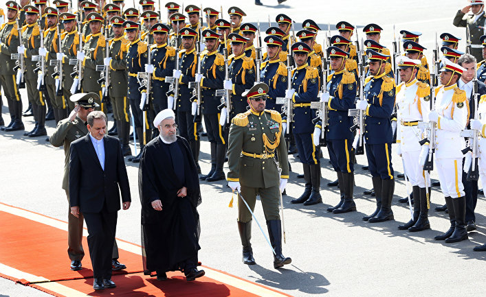 Iran's President Hassan Rouhani, second left, and Vice President Eshagh Jahangiri, left, review the honor guard