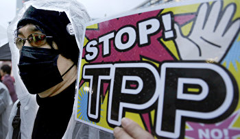 A protester holds a placard during a rally against the Trans-Pacific Partnership (TPP)