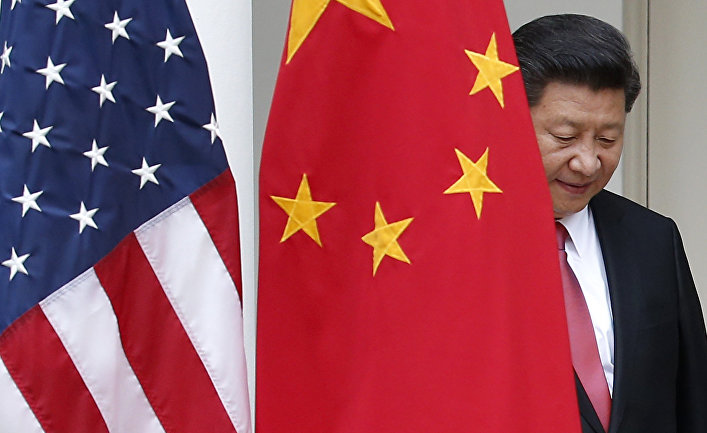 Chinese President Xi Jinping steps out from behind China's flag as he takes his position for his joint news conference with President Barack Obama