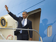 President Barack Obama waves as he boards Air Force One