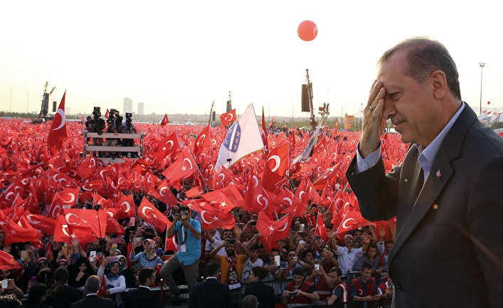 Turkey's President Recep Tayyip Erdogan salutes supporters as tens of thousands of flag-waving demonstrators rally to denounce violence by Kurdish rebels, in Istanbul
