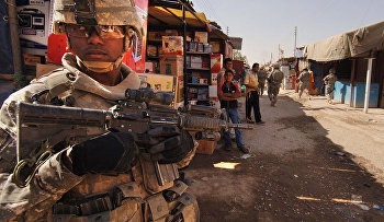 U.S. Army Staff Sgt. Jerrime Bishop provides security during a joint dismounted presence patrol with Iraqi National Police