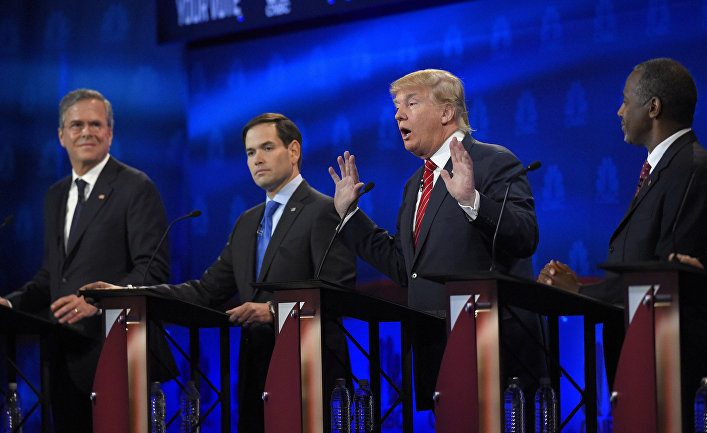 Donald Trump, second from right, speaks as Jeb Bush, left, Marco Rubio, second from left, and Ben Carson look on during the CNBC Republican presidential debate at the University of Colorado