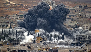 Nov. 17, 2014 file photo, smoke rises from the Syrian city of Kobani, following an airstrike by the U.S.-led coalition
