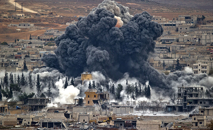 Nov. 17, 2014 file photo, smoke rises from the Syrian city of Kobani, following an airstrike by the U.S.-led coalition