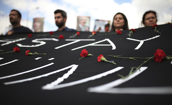 People carry a banner against the bombing attacks in Ankara on Oct. 10, during a protest in Izmir, Turkey