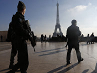 French police officers patrol near the Eiffel Tower, in Paris