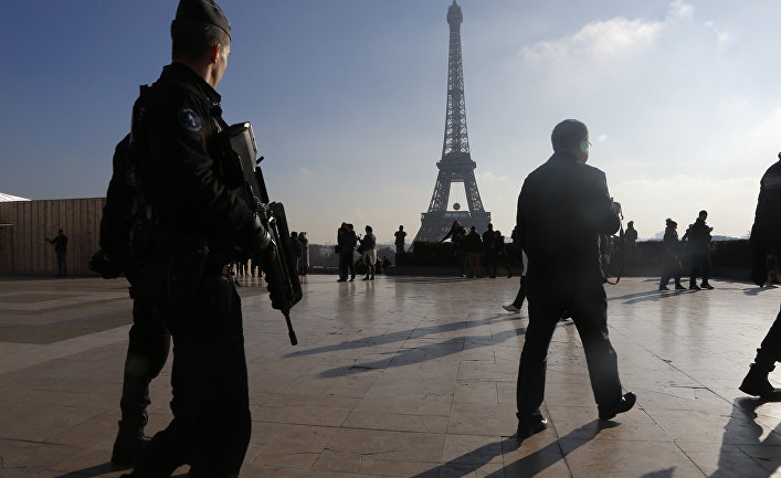 French police officers patrol near the Eiffel Tower, in Paris