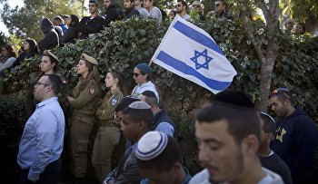Israeli soldiers, relatives and friends mourn at the grave site of 18-year-old Israeli soldier Ziv Mizrahi during his funeral at a military cemetery in Jerusalem
