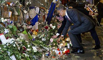 President Barack Obama, right, and French President Francois Hollande place flowers at the Bataclan, site of one of the Paris terrorists attacks, to pay his respects after arriving in town for the COP21 climate change conference