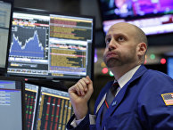 Specialist Meric Greenbaum works at his post on the floor of the New York Stock Exchange, Friday, Dec. 11, 2015