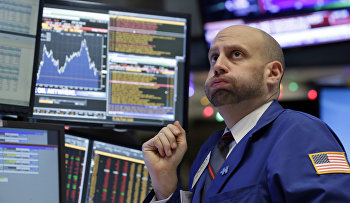 Specialist Meric Greenbaum works at his post on the floor of the New York Stock Exchange, Friday, Dec. 11, 2015