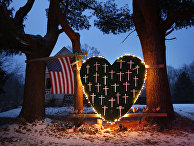 A makeshift memorial with crosses for the victims of the Sandy Hook Elementary School shooting massacre stands outside a home in Newtown, Conn