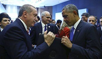 Turkish President Recep Tayyip Erdogan, left, presents a photo album to U.S. President Barack Obama at the end of the G-20 Summit in Antalya, Turkey