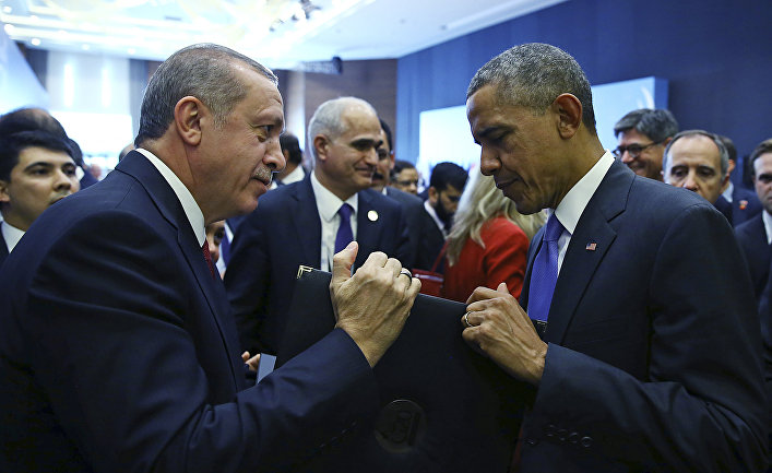 Turkish President Recep Tayyip Erdogan, left, presents a photo album to U.S. President Barack Obama at the end of the G-20 Summit in Antalya, Turkey