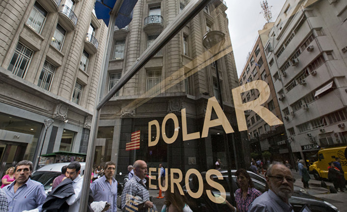People walk outside a money exchange house in Buenos Aires, Argentina