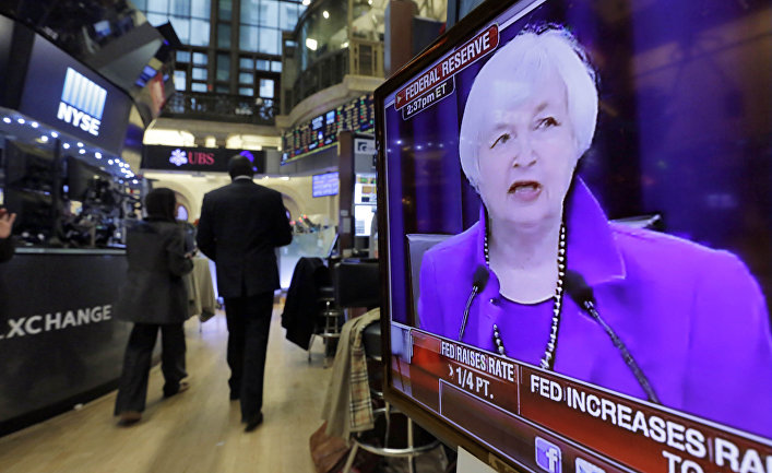 Federal Reserve Chair Janet Yellen's Washington news conference is shown on a television screen on the floor of the New York Stock Exchange, Wednesday, Dec. 16, 2015.