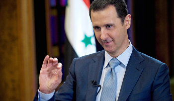 Feb. 10, 2015 file photo released by the Syrian official news agency SANA, Syrian President Bashar Assad gestures during an interview with the BBC, in Damascus, Syria